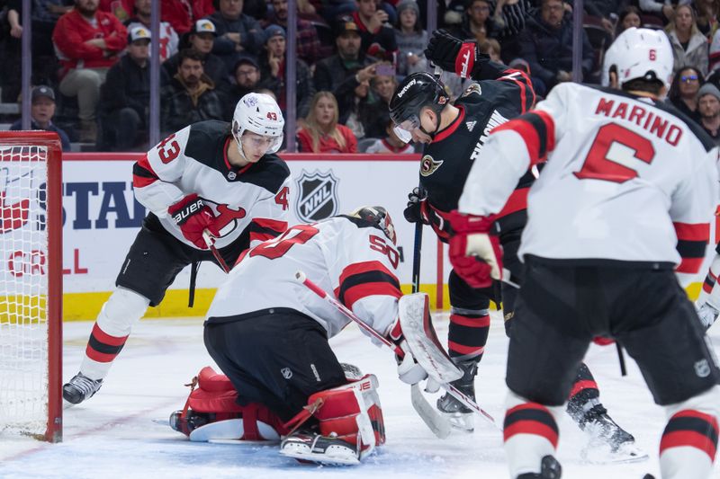 Dec 29, 2023; Ottawa, Ontario, CAN; New Jersey Devils goalie Nico Daws (50) makes a save in front of Ottawa Senators left wing Brady Tkachuk (7) in the first period at the Canadian Tire Centre. Mandatory Credit: Marc DesRosiers-USA TODAY Sports