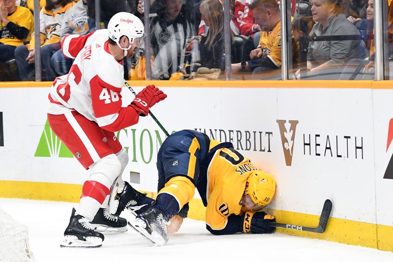 Mar 23, 2024; Nashville, Tennessee, USA; Nashville Predators center Colton Sissons (10) is hit into the boards by Detroit Red Wings defenseman Jeff Petry (46) during the first period at Bridgestone Arena. Mandatory Credit: Christopher Hanewinckel-USA TODAY Sports