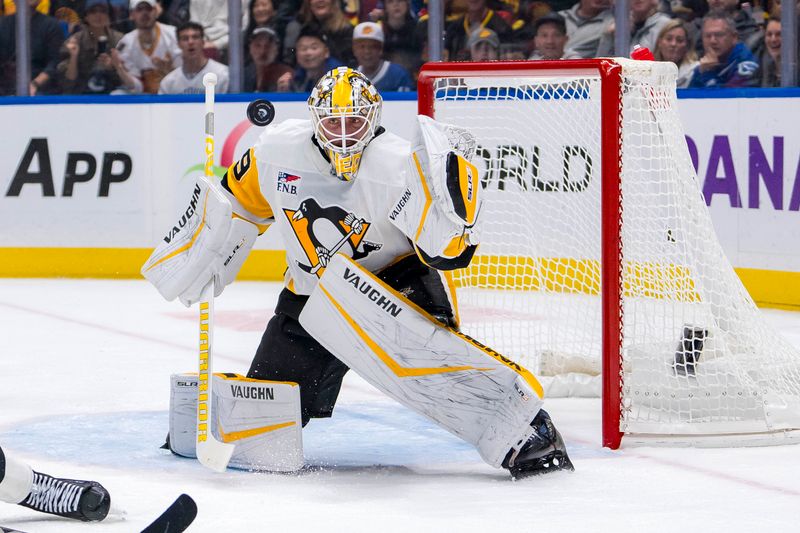 Oct 26, 2024; Vancouver, British Columbia, CAN; Pittsburgh Penguins goalie Alex Nedeljkovic (39) makes a save against the Vancouver Canucks during the first period at Rogers Arena. Mandatory Credit: Bob Frid-Imagn Images