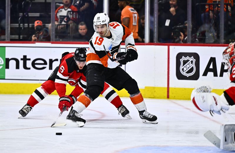 Apr 13, 2024; Philadelphia, Pennsylvania, USA; Philadelphia Flyers right wing Garnet Hathaway (19) passes the puck against New Jersey Devils defenseman John Marino (6) in the third period at Wells Fargo Center. Mandatory Credit: Kyle Ross-USA TODAY Sports