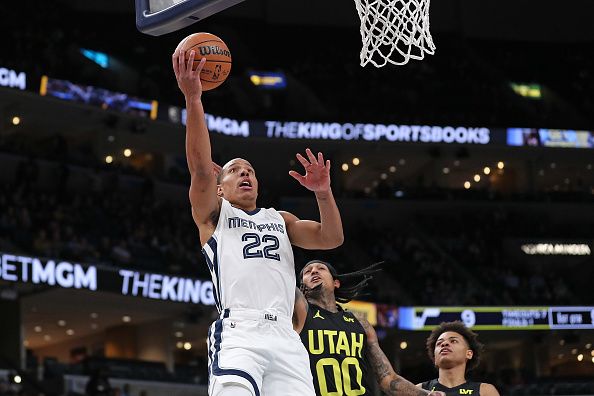 MEMPHIS, TENNESSEE - NOVEMBER 29: Desmond Bane #22 of the Memphis Grizzlies goes to the basket against Jordan Clarkson #00 of the Utah Jazz during the first half at FedExForum on November 29, 2023 in Memphis, Tennessee. NOTE TO USER: User expressly acknowledges and agrees that, by downloading and or using this photograph, User is consenting to the terms and conditions of the Getty Images License Agreement.  (Photo by Justin Ford/Getty Images)