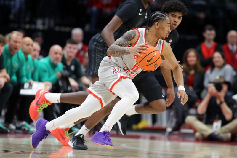 Jan 3, 2025; Columbus, Ohio, USA; Ohio State Buckeyes guard Ques Glover (6) dribbles against Michigan State Spartans guard Jeremy Fears Jr. (1) during the second half at Value City Arena. Mandatory Credit: Joseph Maiorana-Imagn Images