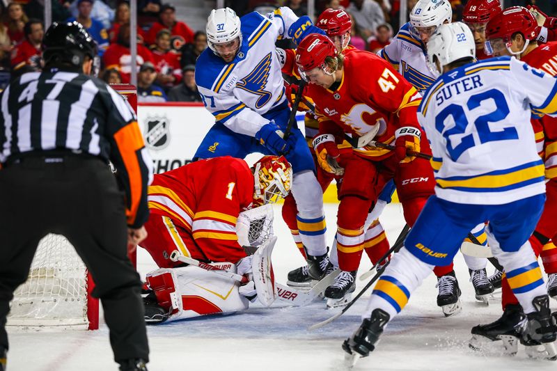 Mar 18, 2026; Calgary, Alberta, CAN; Calgary Flames goaltender Devin Cooley (1) makes a save against the St. Louis Blues during the first period at Scotiabank Saddledome. Mandatory Credit: Sergei Belski-Imagn Images