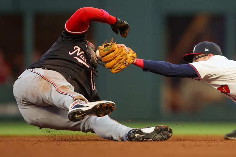 May 14, 2025; Atlanta, Georgia, USA; Atlanta Braves shortstop Nick Allen (2) tags Washington Nationals designated hitter Josh Bell (19) in the fourth inning at Truist Park. Mandatory Credit: Brett Davis-Imagn Images
