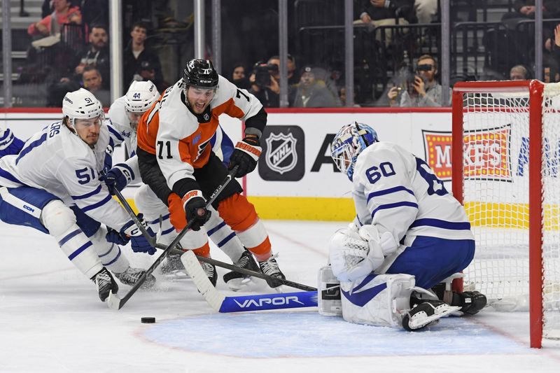 Jan 7, 2025; Philadelphia, Pennsylvania, USA; Philadelphia Flyers right wing Tyson Foerster (71) drives to the net against Toronto Maple Leafs defenseman Philippe Myers (51) and goaltender Joseph Woll (60) during the third period at Wells Fargo Center. Mandatory Credit: Eric Hartline-Imagn Images