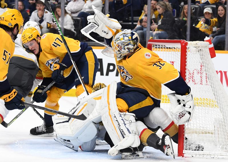 Apr 4, 2023; Nashville, Tennessee, USA; Nashville Predators goaltender Kevin Lankinen (32) falls over Vegas Golden Knights center Brett Howden (21) in the crease during the second period at Bridgestone Arena. Mandatory Credit: Christopher Hanewinckel-USA TODAY Sports