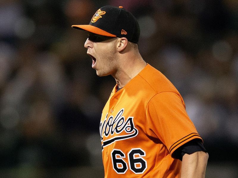 Aug 19, 2023; Oakland, California, USA; Baltimore Orioles pitcher Jacob Webb (66) celebrates the final out against the Oakland Athletics during the 10th inning at Oakland-Alameda County Coliseum. Mandatory Credit: D. Ross Cameron-USA TODAY Sports