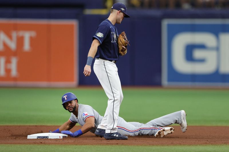 Oct 4, 2023; St. Petersburg, Florida, USA; Texas Rangers center fielder Leody Taveras (3) steals second base against the Tampa Bay Rays in the fourth inning during game two of the Wildcard series for the 2023 MLB playoffs at Tropicana Field. Mandatory Credit: Nathan Ray Seebeck-USA TODAY Sports