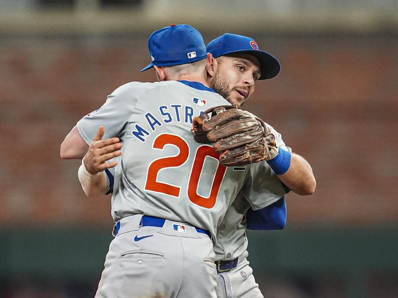 May 15, 2024; Cumberland, Georgia, USA; Chicago Cubs shortstop Miles Mastrobuoni (20) and second baseman Nick Madrigal (1) react after defeating the Atlanta Braves at Truist Park. Mandatory Credit: Dale Zanine-USA TODAY Sports