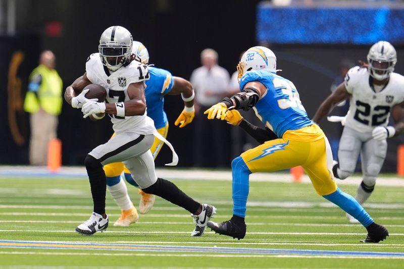 Las Vegas Raiders wide receiver Davante Adams (17) runs against the Los Angeles Chargers during the first half of an NFL football game, Sunday, Sept. 8, 2024, in Inglewood, Calif. (AP Photo/Marcio Jose Sanchez)