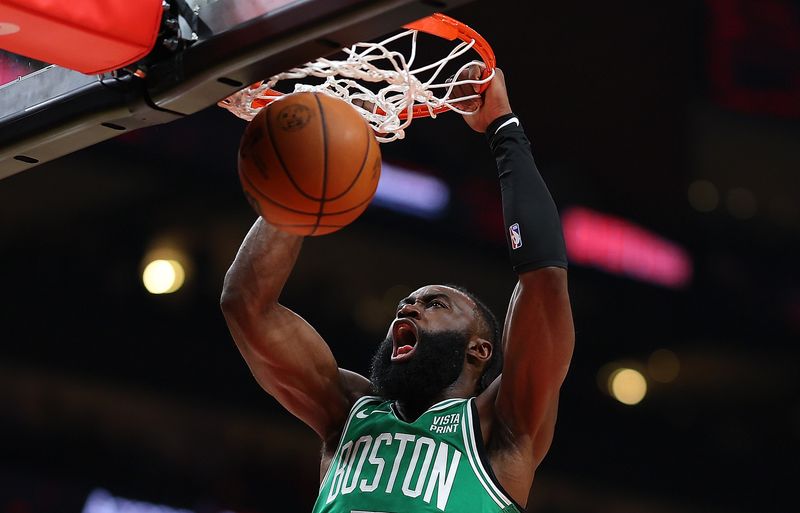 ATLANTA, GEORGIA - MARCH 28:  Jaylen Brown #7 of the Boston Celtics dunks against Bruno Fernando #24 of the Atlanta Hawks during the first quarter at State Farm Arena on March 28, 2024 in Atlanta, Georgia.  NOTE TO USER: User expressly acknowledges and agrees that, by downloading and/or using this photograph, user is consenting to the terms and conditions of the Getty Images License Agreement.  (Photo by Kevin C. Cox/Getty Images)