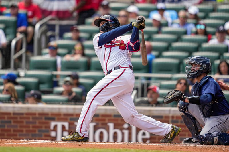 May 21, 2023; Cumberland, Georgia, USA; Atlanta Braves catcher Travis d'Arnaud (16) hits a home run against the Seattle Mariners during the sixth inning at Truist Park. Mandatory Credit: Dale Zanine-USA TODAY Sports