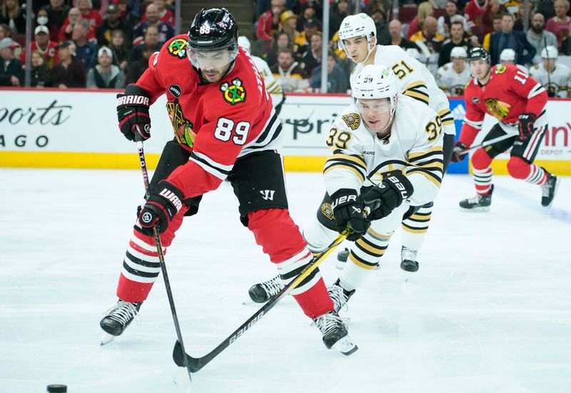 Oct 24, 2023; Chicago, Illinois, USA; Boston Bruins center Morgan Geekie (39) defends Chicago Blackhawks center Andreas Athanasiou (89) during the first period against the Boston Bruins at United Center. Mandatory Credit: David Banks-USA TODAY Sports