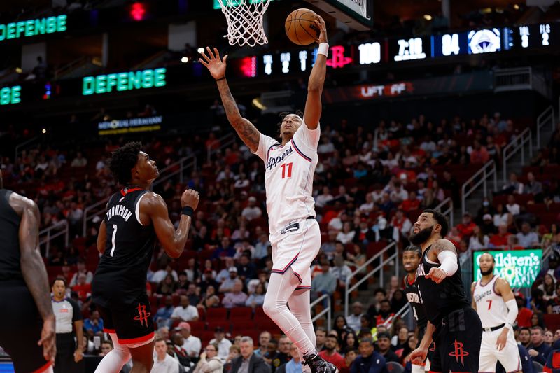 HOUSTON, TEXAS - NOVEMBER 13: Jordan Miller #11 of the Los Angeles Clippers goes up for a lay up against Amen Thompson #1 of the Houston Rockets in the second half at Toyota Center on November 13, 2024 in Houston, Texas.  NOTE TO USER: User expressly acknowledges and agrees that, by downloading and or using this photograph, User is consenting to the terms and conditions of the Getty Images License Agreement.  (Photo by Tim Warner/Getty Images)