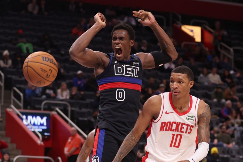 DETROIT, MICHIGAN - JANUARY 12: Jalen Duren #0 of the Detroit Pistons dunks on top of Jabari Smith Jr. #10 of the Houston Rockets during the second half at Little Caesars Arena on January 12, 2024 in Detroit, Michigan. Houston won the game 112-110. NOTE TO USER: User expressly acknowledges and agrees that, by downloading and or using this photograph, User is consenting to the terms and conditions of the Getty Images License  (Photo by Gregory Shamus/Getty Images)