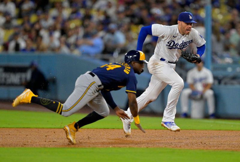 Aug 16, 2023; Los Angeles, California, USA;  Los Angeles Dodgers first baseman Freddie Freeman (5) beats Milwaukee Brewers second baseman Andruw Monasterio (14) back to first for a double play in the fourth inning at Dodger Stadium. Mandatory Credit: Jayne Kamin-Oncea-USA TODAY Sports
