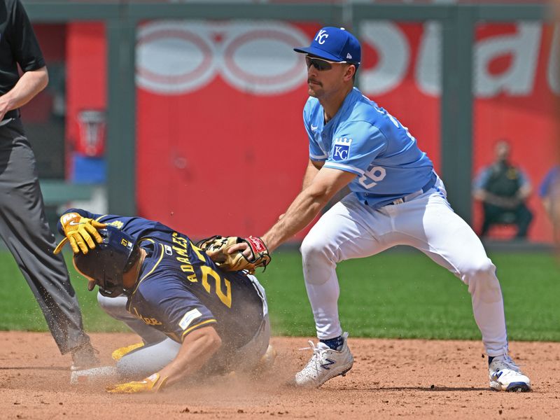 May 8, 2024; Kansas City, Missouri, USA;  Milwaukee Brewers shortstop Willy Adames (27) steals second base against Kansas City Royals second baseman Adam Frazier (26) in the sixth inning at Kauffman Stadium. Mandatory Credit: Peter Aiken-USA TODAY Sports