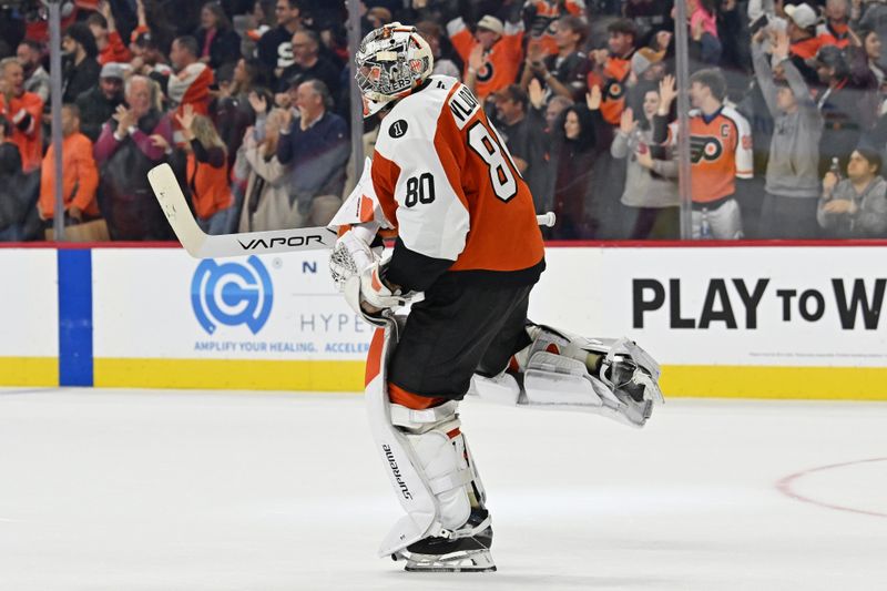 Oct 18, 2025; Philadelphia, Pennsylvania, USA; Philadelphia Flyers goaltender Dan Vladar (80) celebrates win against the Minnesota Wild in overtime at Wells Fargo Center. Mandatory Credit: Eric Hartline-Imagn Images