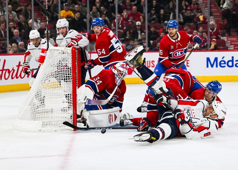 Oct 21, 2023; Montreal, Quebec, CAN; Montreal Canadiens goalie Jake Allen (34) makes a save against Washington Capitals left wing Alex Ovechkin (8) laying on the ice during the first period at Bell Centre. Mandatory Credit: David Kirouac-USA TODAY Sports