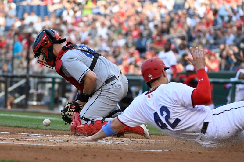 Apr 15, 2023; Washington, District of Columbia, USA; Washington Nationals designated hitter Joey Meneses (45) scores a run past Cleveland Guardians catcher Cam Gallagher (35) during the first inning at Nationals Park. Mandatory Credit: Brad Mills-USA TODAY Sports