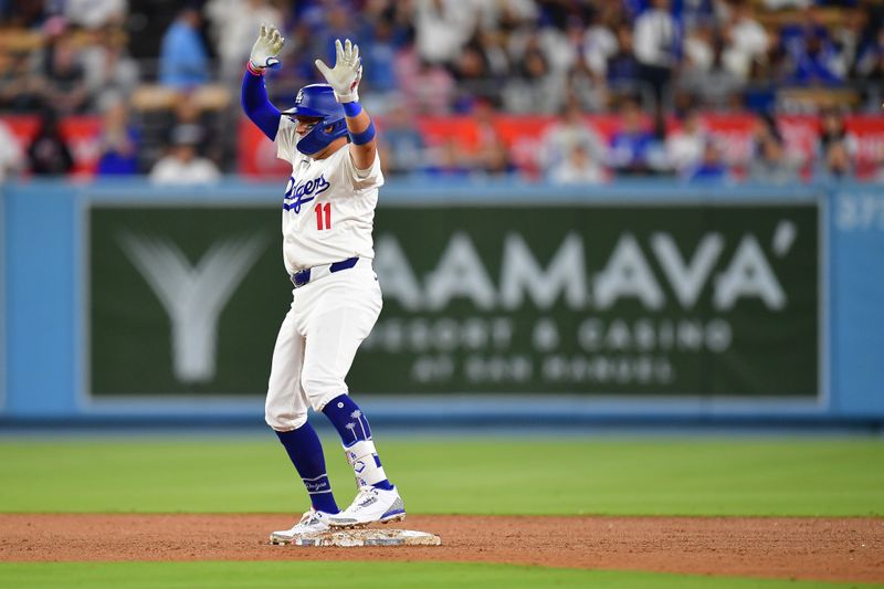 Aug 29, 2024; Los Angeles, California, USA; Los Angeles Dodgers shortstop Miguel Rojas (11) reaches second on a double against the Baltimore Orioles during the seventh inning at Dodger Stadium. Mandatory Credit: Gary A. Vasquez-USA TODAY Sports