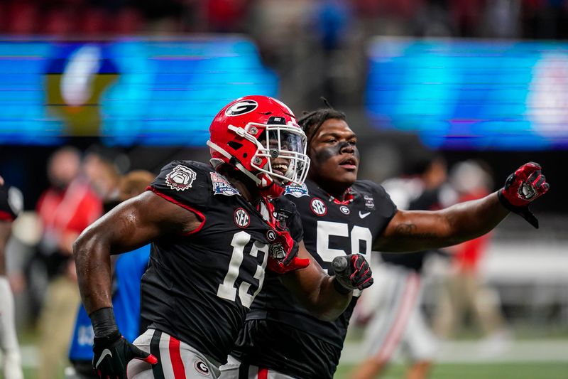 Jan 1, 2021; Atlanta, GA, USA; Georgia Bulldogs linebacker Azeez Ojulari (13) reacts with offensive lineman Broderick Jones (59) after he sacked Cincinnati Bearcats quarterback Desmond Ridder (9) (not shown) for a safety on the games final play during the second half at Mercedes-Benz Stadium. Mandatory Credit: Dale Zanine-USA TODAY Sports