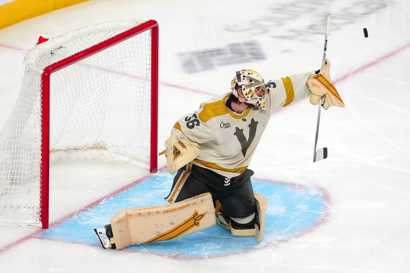 Jan 13, 2024; Las Vegas, Nevada, USA; Vegas Golden Knights goaltender Logan Thompson (36) makes a save against the Calgary Flames during the third period at T-Mobile Arena. Mandatory Credit: Stephen R. Sylvanie-USA TODAY Sports