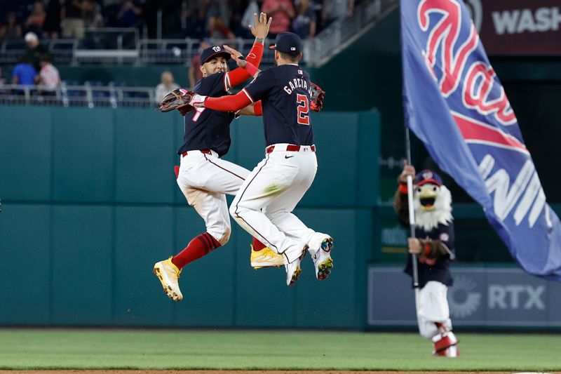 May 24, 2024; Washington, District of Columbia, USA; Washington Nationals outfielder Eddie Rosario (8) and Nationals second baseman Luis García Jr. (2) celebrate after their game against the Seattle Mariners at Nationals Park. Mandatory Credit: Geoff Burke-USA TODAY Sports