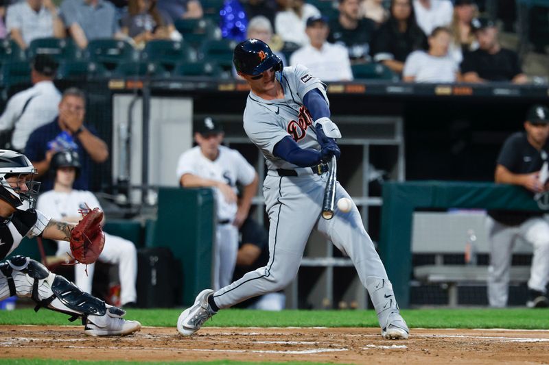 Aug 23, 2024; Chicago, Illinois, USA; Detroit Tigers catcher Dillon Dingler (38) hits an RBI-single against the Chicago White Sox during the second inning at Guaranteed Rate Field. Mandatory Credit: Kamil Krzaczynski-USA TODAY Sports