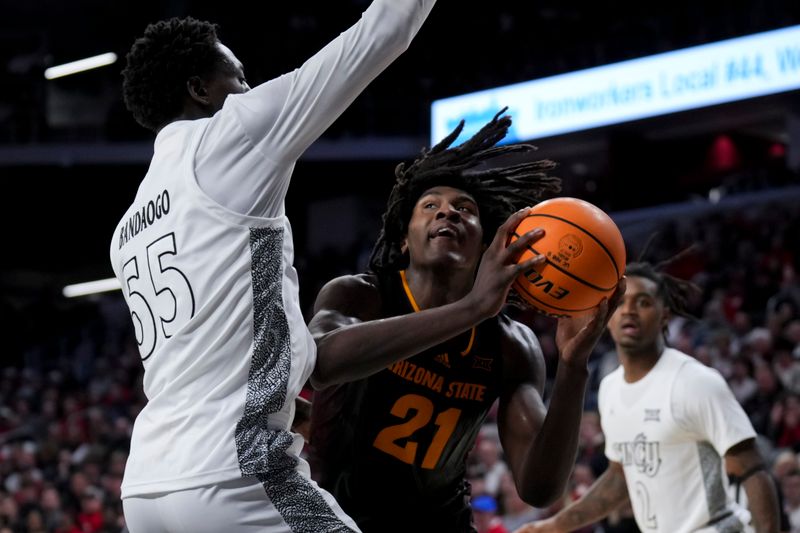 Jan 18, 2025; Cincinnati, Ohio, USA;  Arizona State Sun Devils forward Jayden Quaintance (21) drives to the basket against Cincinnati Bearcats forward Aziz Bandaogo (55) in the second half at Fifth Third Arena. Mandatory Credit: Aaron Doster-Imagn Images