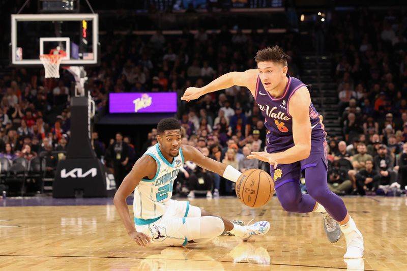 PHOENIX, ARIZONA - DECEMBER 29:  Grayson Allen #8 of the Phoenix Suns drives the ball past Brandon Miller #24 of the Charlotte Hornets during the first half of the NBA game at Footprint Center on December 29, 2023 in Phoenix, Arizona. The Suns defeated the Hornets 133-119. NOTE TO USER: User expressly acknowledges and agrees that, by downloading and or using this photograph, User is consenting to the terms and conditions of the Getty Images License Agreement.  (Photo by Christian Petersen/Getty Images)