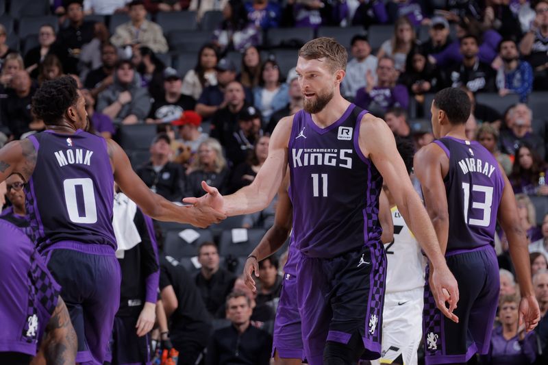 SACRAMENTO, CA - DECEMBER 8: Malik Monk #0 and Domantas Sabonis #11 of the Sacramento Kings high five during the game against the Utah Jazz on December 8, 2024 at Golden 1 Center in Sacramento, California. NOTE TO USER: User expressly acknowledges and agrees that, by downloading and or using this Photograph, user is consenting to the terms and conditions of the Getty Images License Agreement. Mandatory Copyright Notice: Copyright 2024 NBAE (Photo by Rocky Widner/NBAE via Getty Images)