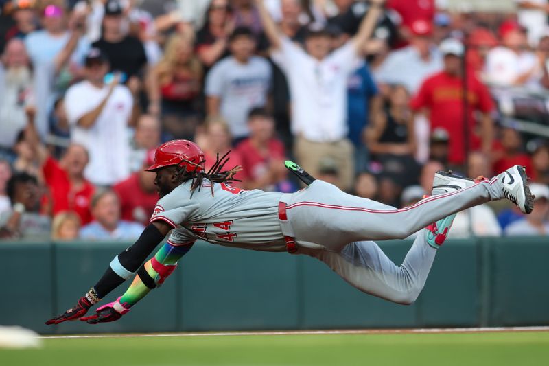 Jul 22, 2024; Atlanta, Georgia, USA; Cincinnati Reds shortstop Elly De La Cruz (44) slides in with a triple against the Atlanta Braves in the first inning at Truist Park. Mandatory Credit: Brett Davis-USA TODAY Sports