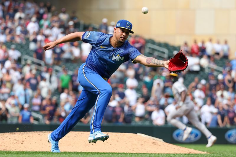 Jun 16, 2024; Minneapolis, Minnesota, USA; Minnesota Twins pitcher Jhoan Duran (59) attempts to field a ground ball hit by Oakland Athletics second baseman Abraham Toro (31) during the ninth inning of game one of a double header at Target Field. Mandatory Credit: Matt Krohn-USA TODAY Sports