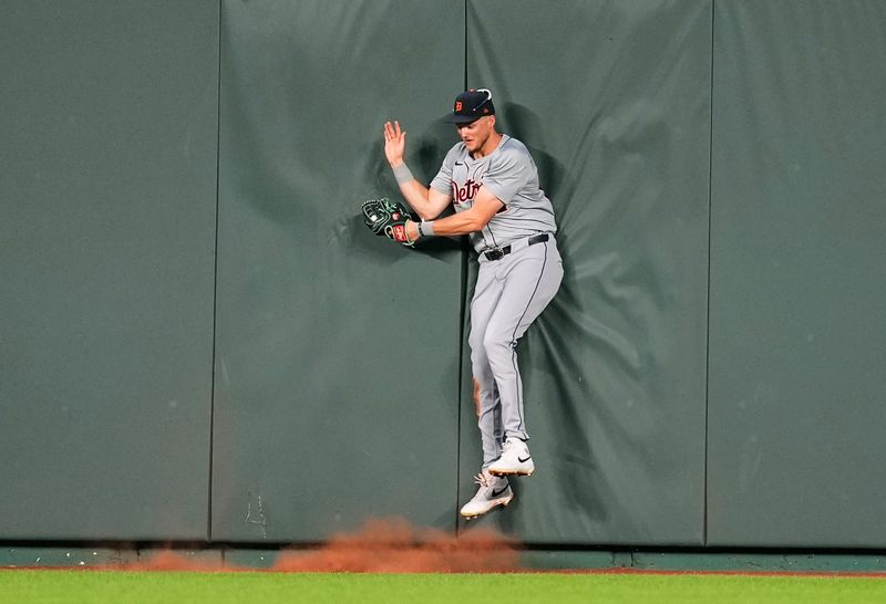 Sep 17, 2024; Kansas City, Missouri, USA; Detroit Tigers center fielder Parker Meadows (22) crashes into the wall after making a catch at the wall during the third inning against the Kansas City Royals at Kauffman Stadium. Mandatory Credit: Jay Biggerstaff-Imagn Images