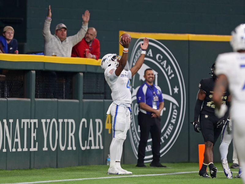 Nov 5, 2022; Arlington, Texas, USA; Air Force Falcons quarterback Haaziq Daniels (4) celebrates his touchdown against the Army Black Knights during the second half at the Commanders    Classic at Globe Life Field. Mandatory Credit: Danny Wild-USA TODAY Sports