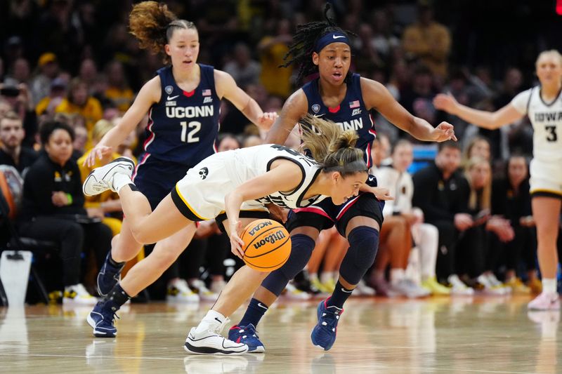 Apr 5, 2024; Cleveland, OH, USA; Iowa Hawkeyes guard Gabbie Marshall (24) controls the ball against Connecticut Huskies guard KK Arnold (2) in the fourth quarter in the semifinals of the Final Four of the womens 2024 NCAA Tournament at Rocket Mortgage FieldHouse. Mandatory Credit: Kirby Lee-USA TODAY Sports