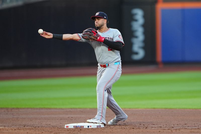 Jul 10, 2024; New York City, New York, USA; Washington Nationals second baseman Luis Garcia Jr. (2) turns a double play on a ground ball hit by New York Mets center fielder Tyrone Taylor (not pictured) during the second inning at Citi Field. Mandatory Credit: Gregory Fisher-USA TODAY Sports