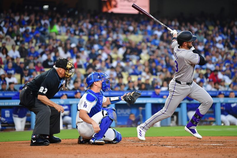 May 31, 2024; Los Angeles, California, USA; Colorado Rockies designated hitter Kris Bryant (23) hits an RBI single against the Los Angeles Dodgers during the third inning at Dodger Stadium. Mandatory Credit: Gary A. Vasquez-USA TODAY Sports