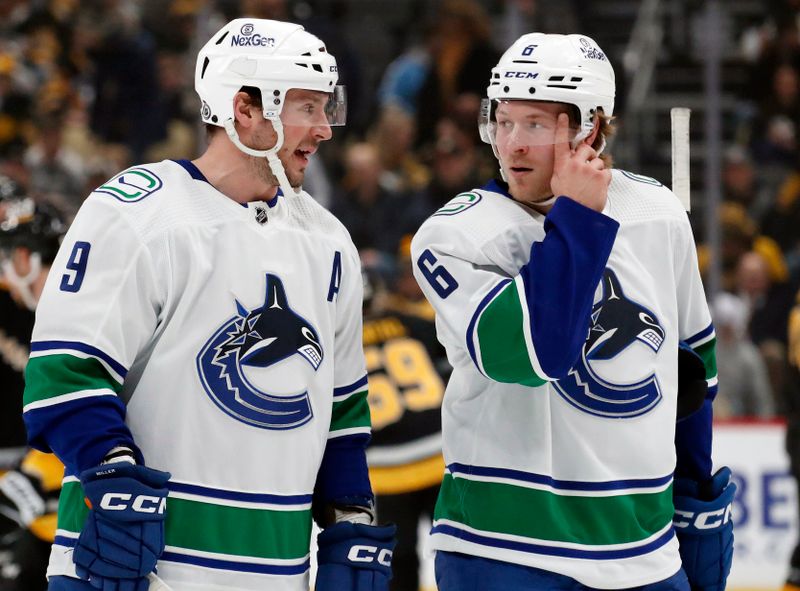 Jan 11, 2024; Pittsburgh, Pennsylvania, USA; Vancouver Canucks center J.T. Miller (9) and right wing Brock Boeser (6) talk on the ice against the Pittsburgh Penguins during the first period at PPG Paints Arena. Mandatory Credit: Charles LeClaire-USA TODAY Sports