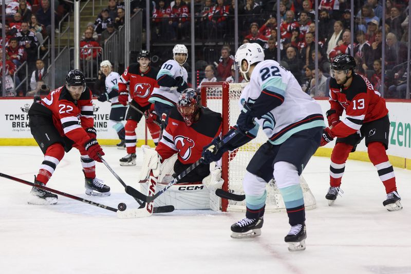 Dec 6, 2024; Newark, New Jersey, USA; New Jersey Devils defenseman Brett Pesce (22) and Seattle Kraken right wing Oliver Bjorkstrand (22) battle for the puck in front of New Jersey Devils goaltender Jacob Markstrom (25) during the third period at Prudential Center. Mandatory Credit: Ed Mulholland-Imagn Images