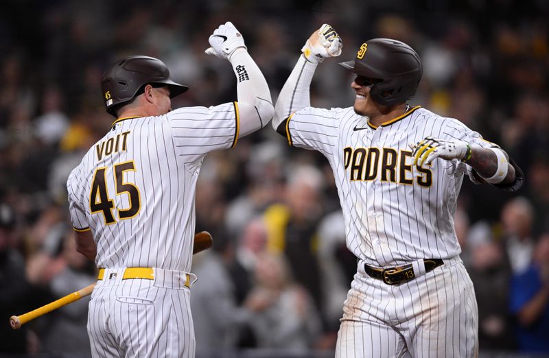 Apr 14, 2022; San Diego, California, USA; San Diego Padres third baseman Manny Machado (right) is congratulated by designated hitter Luke Voit (45) after hitting a two-run home run during the seventh inning against the Atlanta Braves at Petco Park. Mandatory Credit: Orlando Ramirez-USA TODAY Sports