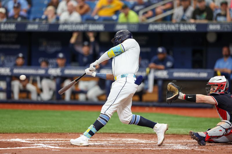 Sep 5, 2024; St. Petersburg, Florida, USA; Tampa Bay Rays third baseman Junior Caminero (13) hits a two rub single against the Minnesota Twins in the third inning  at Tropicana Field. Mandatory Credit: Nathan Ray Seebeck-Imagn Images