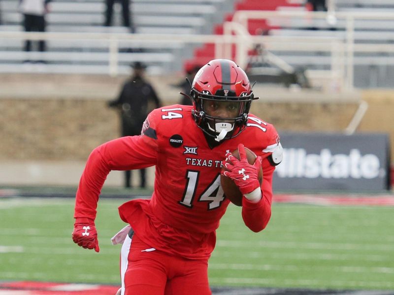 Dec 5, 2020; Lubbock, Texas, USA;  Texas Tech Red Raiders running back Xavier White (14) rushes against the Kansas Jayhawks in the first half at Jones AT&T Stadium. Mandatory Credit: Michael C. Johnson-USA TODAY Sports