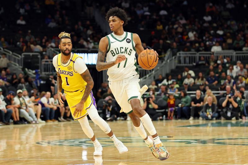 MILWAUKEE, WISCONSIN - OCTOBER 10: AJ Johnson #77 of the Milwaukee Bucks drives around D'Angelo Russell #1 of the Los Angeles Lakers during the second half of a preseason game at Fiserv Forum on October 10, 2024 in Milwaukee, Wisconsin.  NOTE TO USER: User expressly acknowledges and agrees that, by downloading and or using this photograph, User is consenting to the terms and conditions of the Getty Images License Agreement. (Photo by Stacy Revere/Getty Images)