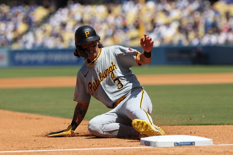 Aug 11, 2024; Los Angeles, California, USA;  Pittsburgh Pirates right fielder Ji Hwan Bae (3) slides to third base on a tag up play during the third inning against the Los Angeles Dodgers at Dodger Stadium. Mandatory Credit: Kiyoshi Mio-USA TODAY Sports