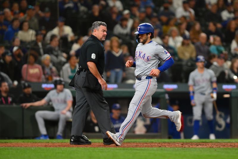 Sep 12, 2024; Seattle, Washington, USA; Texas Rangers shortstop Josh Smith (8) scores a run against the Seattle Mariners during the eighth inning at T-Mobile Park. Mandatory Credit: Steven Bisig-Imagn Images