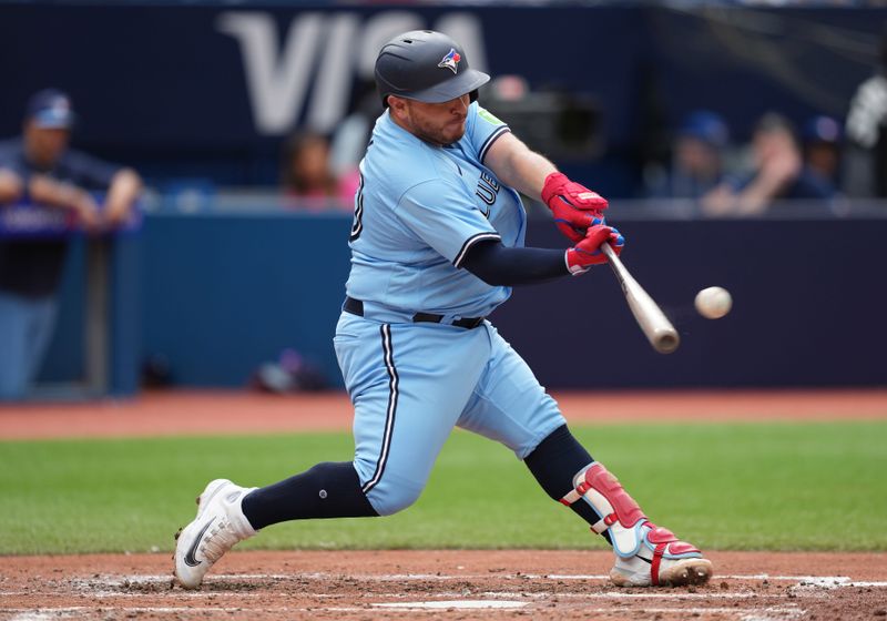 Aug 30, 2023; Toronto, Ontario, CAN; Toronto Blue Jays catcher Alejandro Kirk (30) hits a double against the Washington Nationals during the fourth inning at Rogers Centre. Mandatory Credit: Nick Turchiaro-USA TODAY Sports