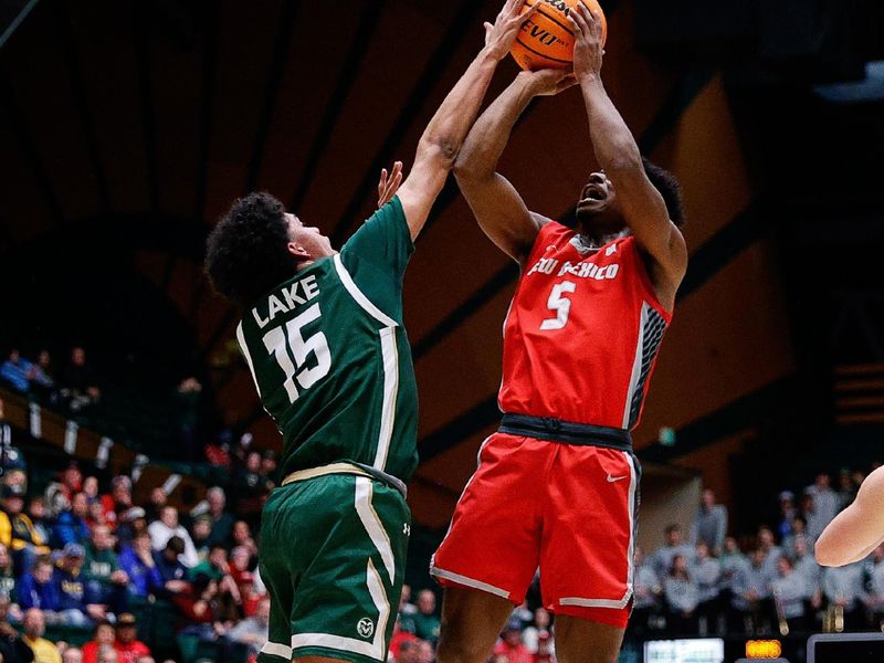 Mar 3, 2023; Fort Collins, Colorado, USA; Colorado State Rams guard Jalen Lake (15) blocks the shot of New Mexico Lobos guard Jamal Mashburn Jr. (5) in the first half at Moby Arena. Mandatory Credit: Isaiah J. Downing-USA TODAY Sports