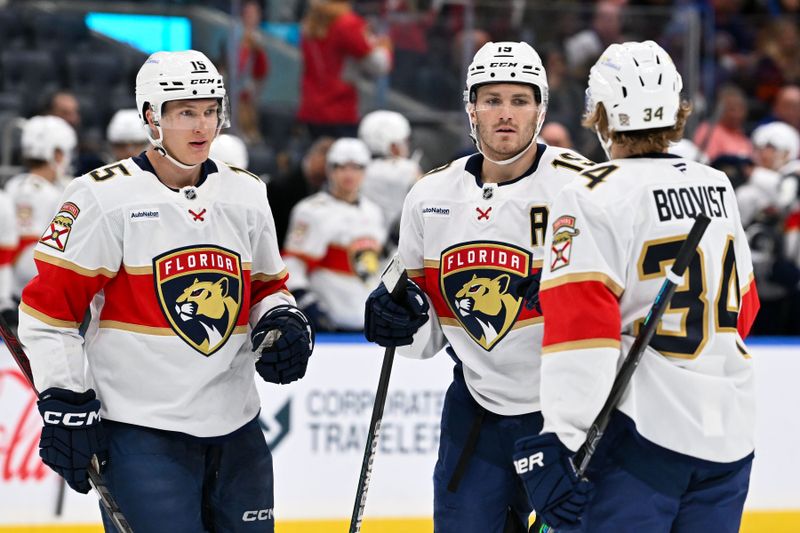 Oct 26, 2024; Elmont, New York, USA;  Florida Panthers left wing Matthew Tkachuk (19) celebrates his goal with Florida Panthers center Anton Lundell (15) and Florida Panthers defenseman Adam Boqvist (34) against the New York Islanders during the third period at UBS Arena. Mandatory Credit: Dennis Schneidler-Imagn Images